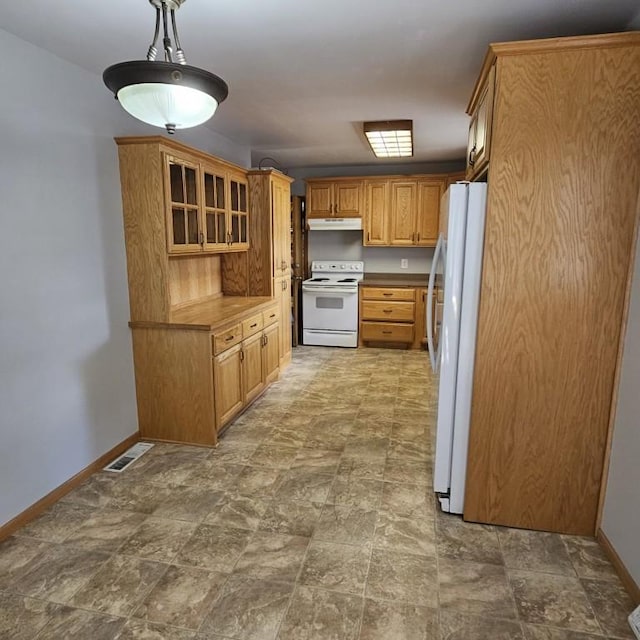 410 9th St, Morris, MN 56267 - kitchen with white appliances, under cabinet range hood, baseboards, glass insert cabinets, and stone finish floors