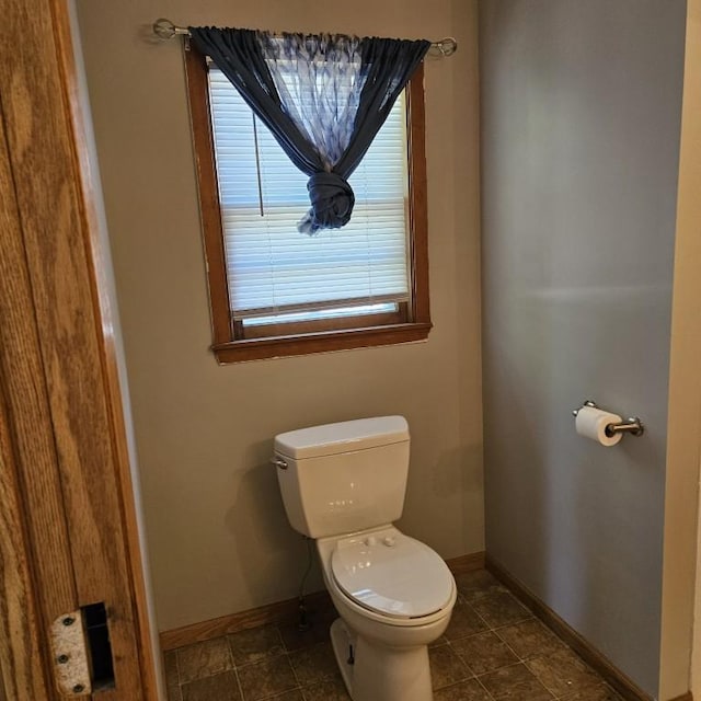 410 9th St, Morris, MN 56267 - bathroom featuring baseboards and toilet