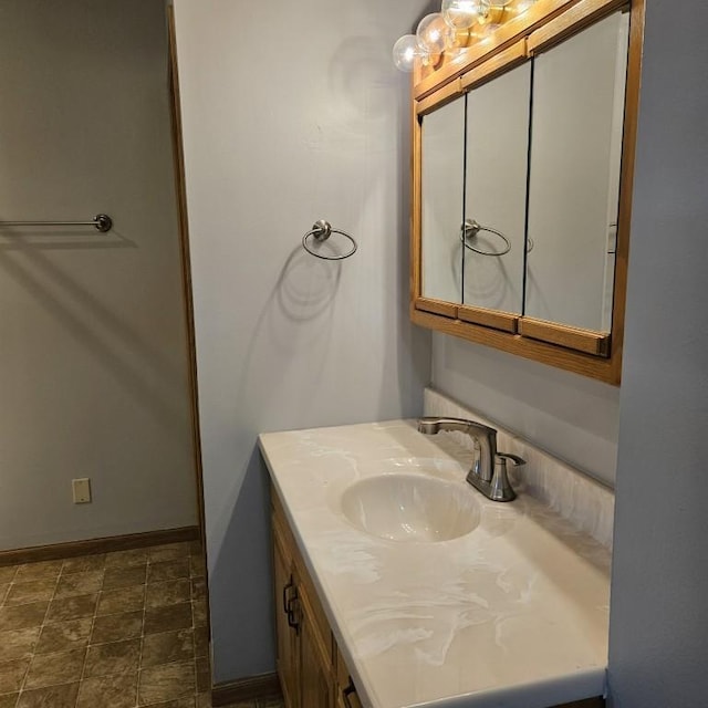 410 9th St, Morris, MN 56267 - bathroom with vanity, baseboards, and stone finish floors