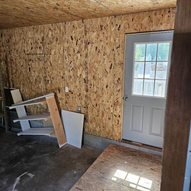 410 9th St, Morris, MN 56267 - doorway to outside featuring unfinished concrete floors and stairs
