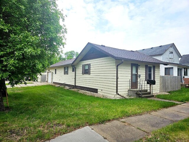 410 9th St, Morris, MN 56267 - view of side of home with a garage and roof with shingles