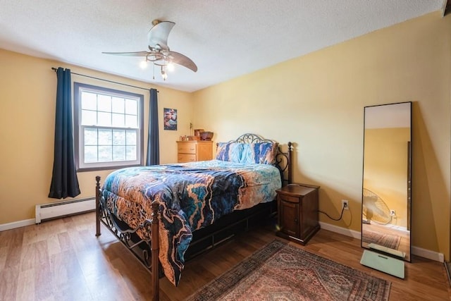 811 Smetana Rd Unit 8, Hopkins, MN 55343 - bedroom with a baseboard radiator, wood finished floors, baseboards, and ceiling fan