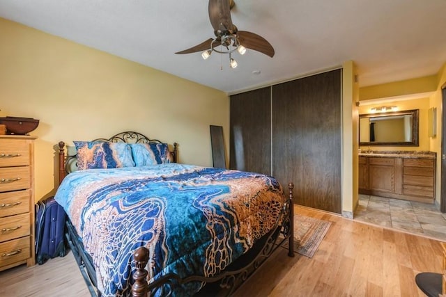 811 Smetana Rd Unit 8, Hopkins, MN 55343 - bedroom with light wood-type flooring, ensuite bathroom, and a ceiling fan