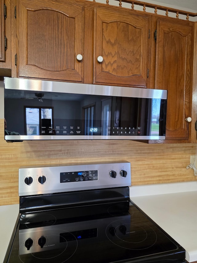 405 16th Ave NE, Waseca, MN 56093 - kitchen view of stainless steel appliances, brown cabinets, and light countertops