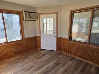 405 16th Ave NE, Waseca, MN 56093 - doorway with a wainscoted wall, wooden walls, wood finished floors, and a wall mounted AC