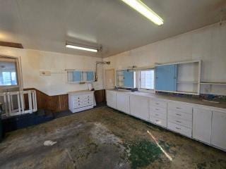 405 16th Ave NE, Waseca, MN 56093 - kitchen with white cabinetry and concrete flooring