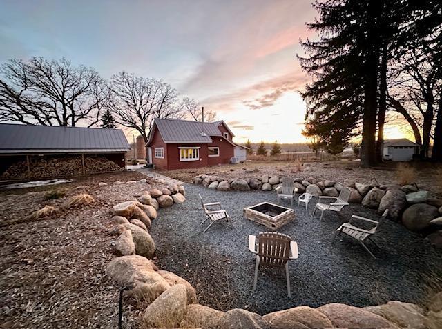 40580 Bow Trl, Nerstrand, MN 55053 - yard at dusk with an outdoor fire pit