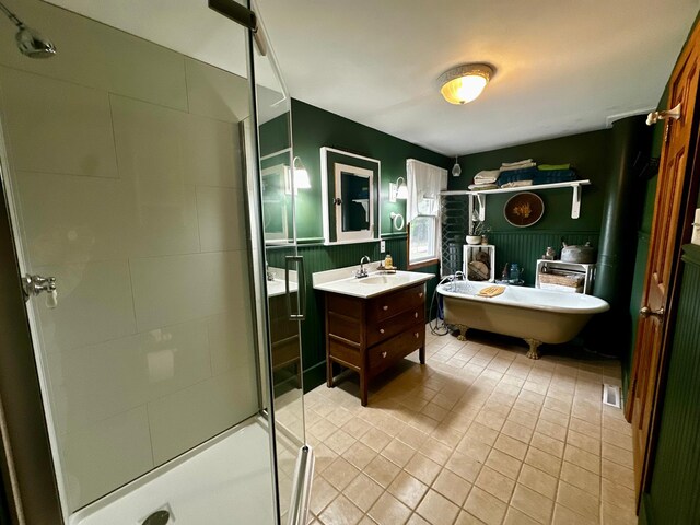 40580 Bow Trl, Nerstrand, MN 55053 - bathroom featuring vanity, a stall shower, tile patterned floors, a freestanding tub, and a wainscoted wall