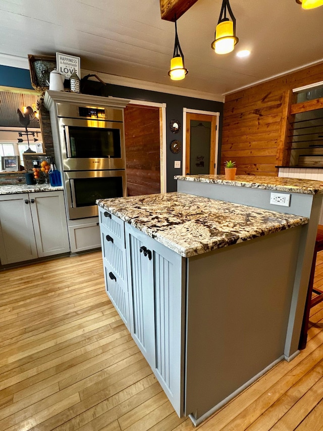 40580 Bow Trl, Nerstrand, MN 55053 - kitchen with double oven, light wood finished floors, light stone countertops, and ornamental molding