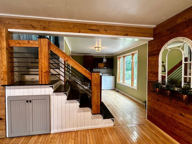 40580 Bow Trl, Nerstrand, MN 55053 - stairway with washer / clothes dryer, wood walls, and wood-type flooring