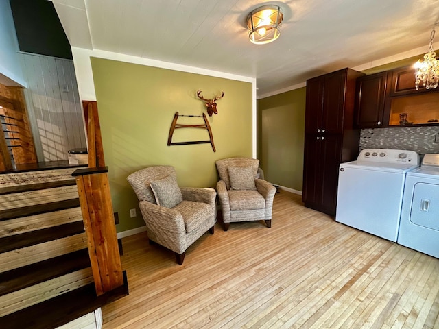 40580 Bow Trl, Nerstrand, MN 55053 - living area with washing machine and dryer, light wood finished floors, and a chandelier