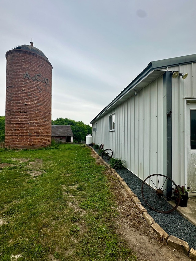 40580 Bow Trl, Nerstrand, MN 55053 - view of home's exterior featuring board and batten siding and a lawn
