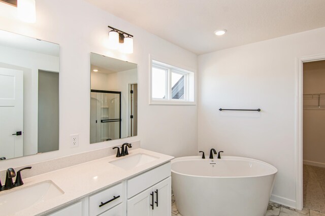 12114 Ivy St, Rogers, MN 55369 - full bathroom featuring a freestanding tub, double vanity, a spacious closet, marble finish floors, and a shower with door