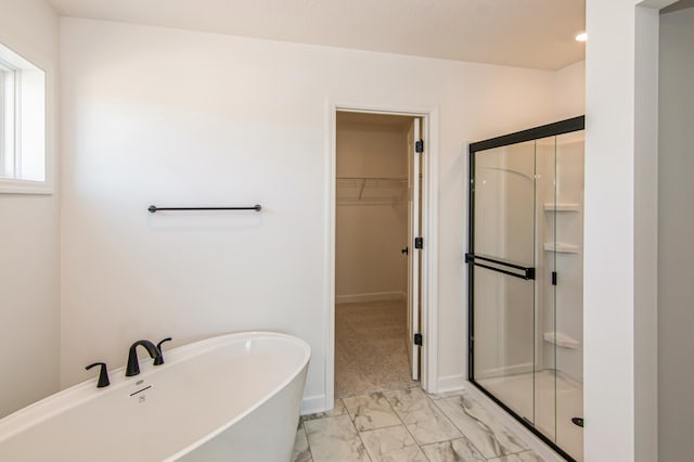 12114 Ivy St, Rogers, MN 55369 - bathroom featuring marble look tiles, a shower stall, a spacious closet, and a freestanding bath