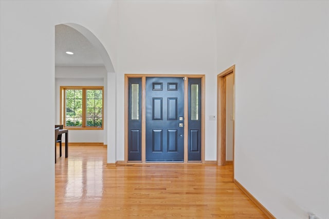 27285 Cambodia Ave, Castle Rock Twp, MN 55024 - foyer entrance with arched walkways, light wood-type flooring, and baseboards