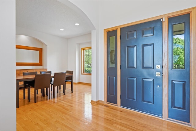 27285 Cambodia Ave, Castle Rock Twp, MN 55024 - foyer featuring arched walkways, light wood-style floors, baseboards, and recessed lighting