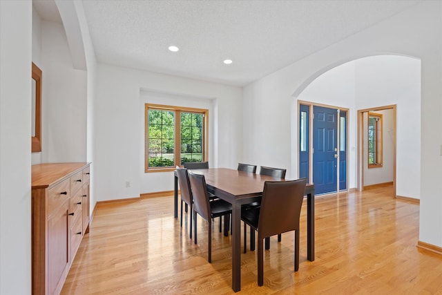 27285 Cambodia Ave, Castle Rock Twp, MN 55024 - dining area featuring arched walkways, light wood finished floors, baseboards, recessed lighting, and a textured ceiling