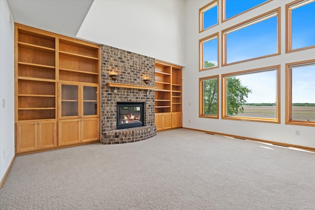 27285 Cambodia Ave, Castle Rock Twp, MN 55024 - unfurnished living room featuring built in shelves, baseboards, and plenty of natural light