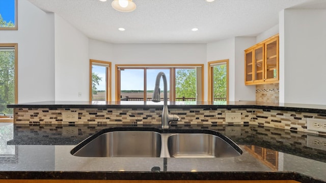 27285 Cambodia Ave, Castle Rock Twp, MN 55024 - kitchen with a sink, backsplash, dark stone countertops, healthy amount of natural light, and recessed lighting