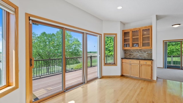 27285 Cambodia Ave, Castle Rock Twp, MN 55024 - kitchen featuring tasteful backsplash, light wood finished floors, glass insert cabinets, dark countertops, and recessed lighting