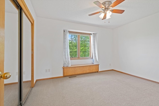 27285 Cambodia Ave, Castle Rock Twp, MN 55024 - unfurnished bedroom with light colored carpet, a textured ceiling, baseboards, and a closet