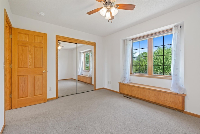 27285 Cambodia Ave, Castle Rock Twp, MN 55024 - unfurnished bedroom with carpet, baseboards, a closet, and ceiling fan