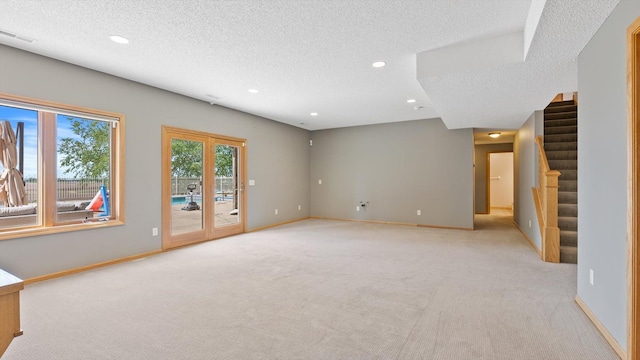 27285 Cambodia Ave, Castle Rock Twp, MN 55024 - unfurnished living room with light carpet, stairway, recessed lighting, a textured ceiling, and baseboards