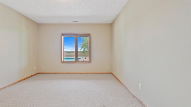 27285 Cambodia Ave, Castle Rock Twp, MN 55024 - unfurnished room with baseboards, light colored carpet, and a textured ceiling