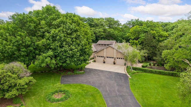1405 Farm Rd, Chanhassen, MN 55318 - view of property hidden behind natural elements with asphalt driveway, a front yard, and an attached garage