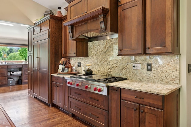 1405 Farm Rd, Chanhassen, MN 55318 - kitchen with stainless steel gas stovetop, custom exhaust hood, tasteful backsplash, wood finished floors, and light stone countertops