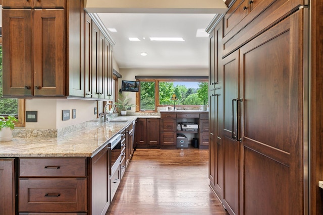 1405 Farm Rd, Chanhassen, MN 55318 - kitchen featuring paneled fridge, wood finished floors, a sink, light stone countertops, and recessed lighting