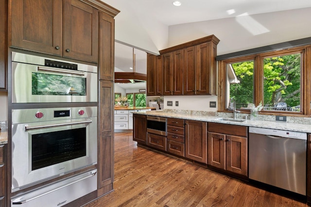 1405 Farm Rd, Chanhassen, MN 55318 - kitchen featuring stainless steel appliances, a sink, a warming drawer, dark wood finished floors, and light stone counters