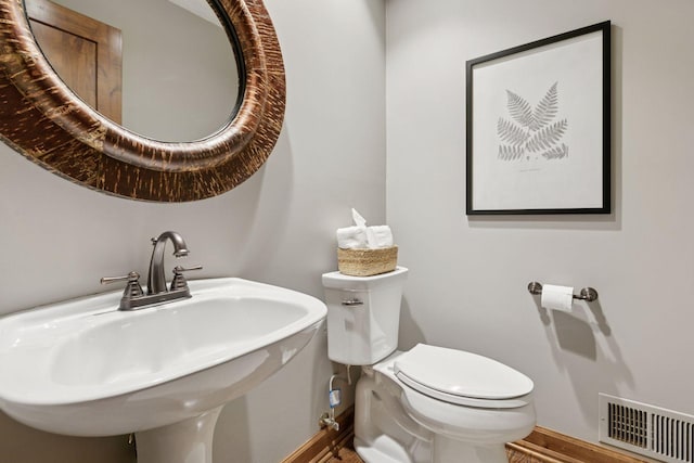 1405 Farm Rd, Chanhassen, MN 55318 - half bath with baseboards, a sink, toilet, and wood finished floors