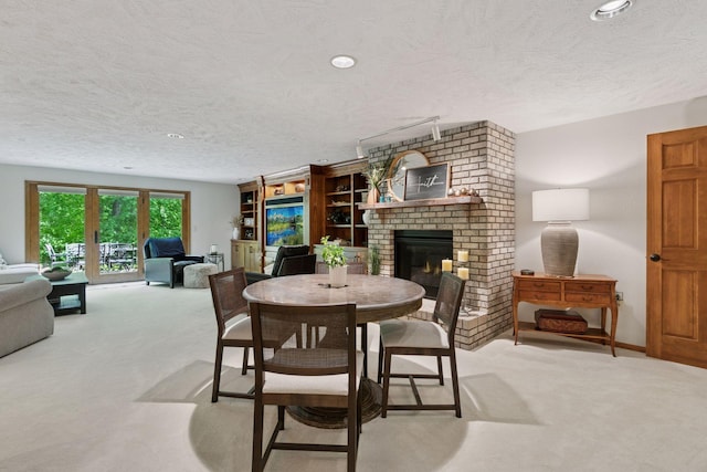 1405 Farm Rd, Chanhassen, MN 55318 - dining room featuring light carpet, a textured ceiling, a fireplace, and recessed lighting