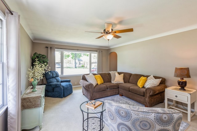 613 9th St NW, Faribault, MN 55021 - carpeted living room featuring ceiling fan, crown molding, and arched walkways