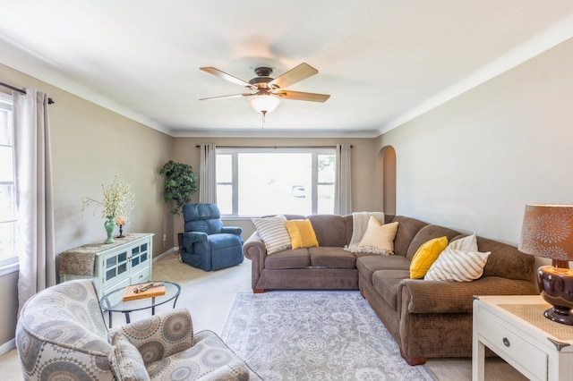 613 9th St NW, Faribault, MN 55021 - living room with arched walkways, ceiling fan, and light carpet