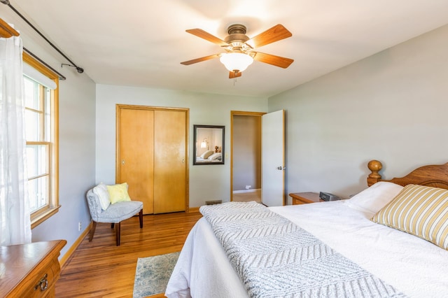 613 9th St NW, Faribault, MN 55021 - bedroom with wood finished floors, a closet, baseboards, and ceiling fan