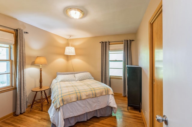 613 9th St NW, Faribault, MN 55021 - bedroom with wood finished floors and baseboards