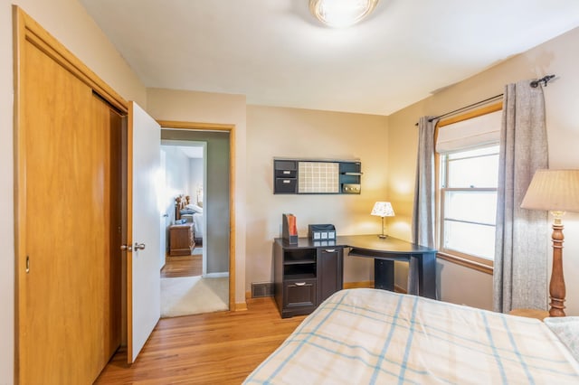 613 9th St NW, Faribault, MN 55021 - bedroom with light wood finished floors, baseboards, and a closet