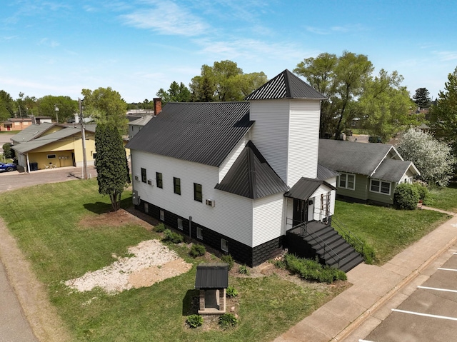 324 Douglas St, Chetek, WI 54728 - view of side of home featuring metal roof, a yard, and uncovered parking
