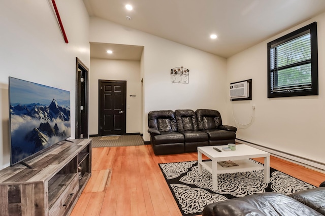 324 Douglas St, Chetek, WI 54728 - living room featuring a baseboard heating unit, light wood-style floors, lofted ceiling, a wall mounted air conditioner, and recessed lighting