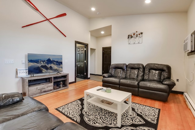 324 Douglas St, Chetek, WI 54728 - living area featuring a baseboard heating unit, wood finished floors, vaulted ceiling, recessed lighting, and baseboards