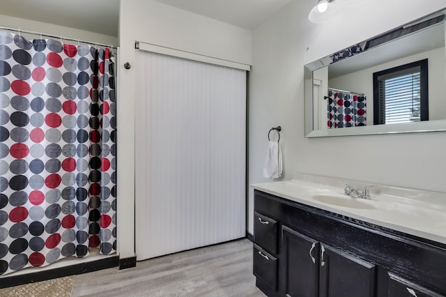 324 Douglas St, Chetek, WI 54728 - full bathroom featuring wood finished floors, vanity, and curtained shower