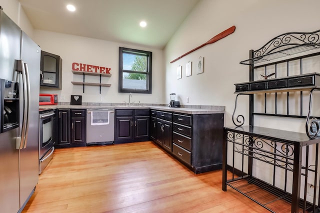 324 Douglas St, Chetek, WI 54728 - kitchen with stainless steel appliances, a sink, light wood finished floors, open shelves, and light countertops