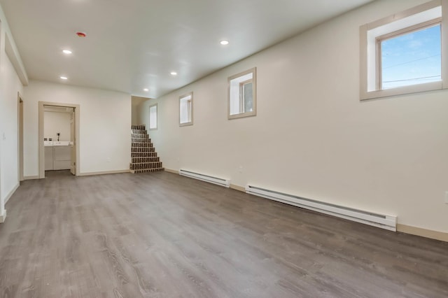324 Douglas St, Chetek, WI 54728 - below grade area featuring a baseboard heating unit, wood finished floors, stairs, recessed lighting, and baseboards