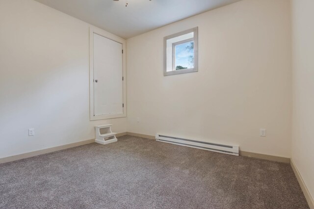 324 Douglas St, Chetek, WI 54728 - empty room with baseboard heating, carpet flooring, and baseboards