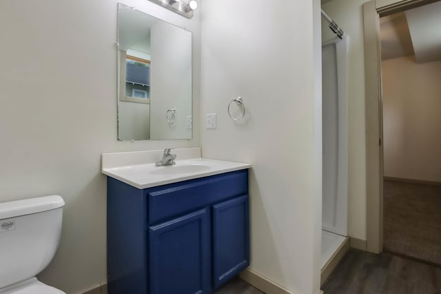 324 Douglas St, Chetek, WI 54728 - full bathroom with a stall shower, vanity, toilet, and wood finished floors