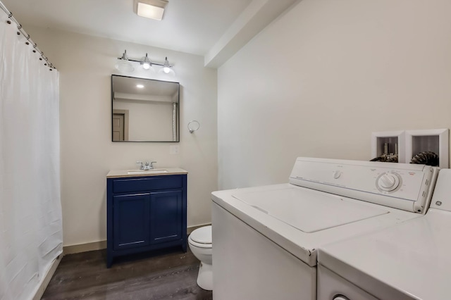324 Douglas St, Chetek, WI 54728 - bathroom featuring independent washer and dryer, vanity, wood finished floors, and toilet
