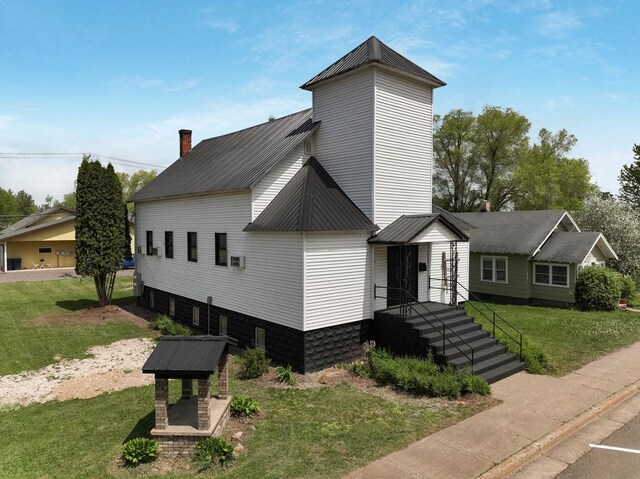 324 Douglas St, Chetek, WI 54728 - view of front of home featuring metal roof, a front yard, and a chimney