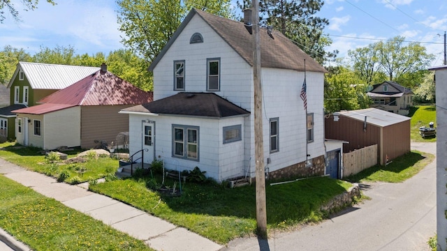 202 6th Ave, Bovey, MN 55709 - view of front of home with roof with shingles and a front yard